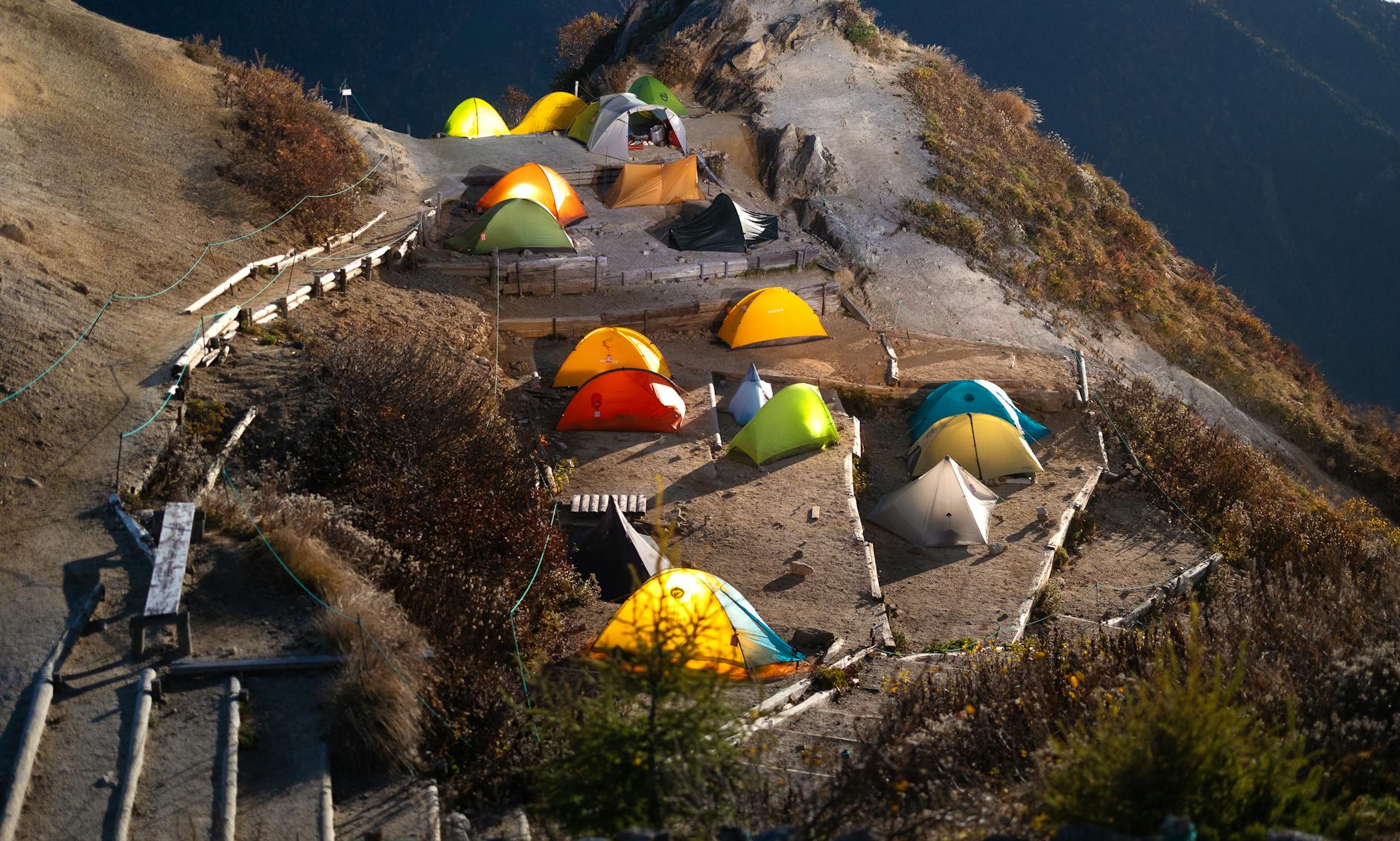 Aerial view of vibrant camping tents in the scenic Japanese Alps.